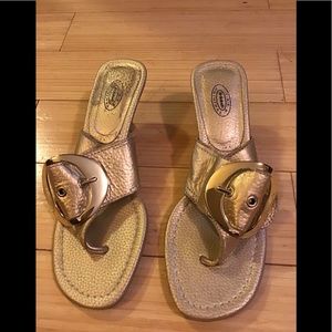 Gold flip flops with large buckle